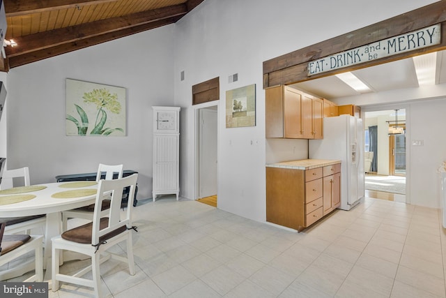 11174 Glade Dr, Reston, VA 20191 - kitchen featuring white refrigerator with ice dispenser, high vaulted ceiling, light countertops, wooden ceiling with exposed beams, and light brown cabinetry
