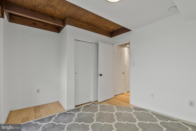 11174 Glade Dr, Reston, VA 20191 - unfurnished bedroom with wooden ceiling, wood finished floors, a closet, and baseboards