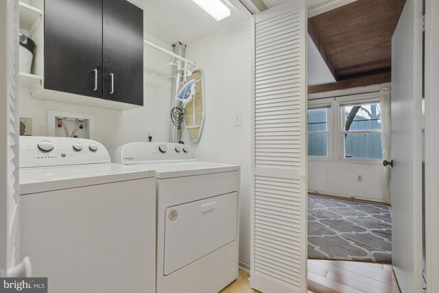 11174 Glade Dr, Reston, VA 20191 - laundry room with cabinet space, washer and clothes dryer, and light wood-type flooring