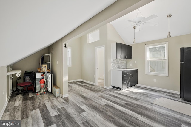 11174 Glade Dr, Reston, VA 20191 - living room featuring vaulted ceiling, wood finished floors, a ceiling fan, and baseboards