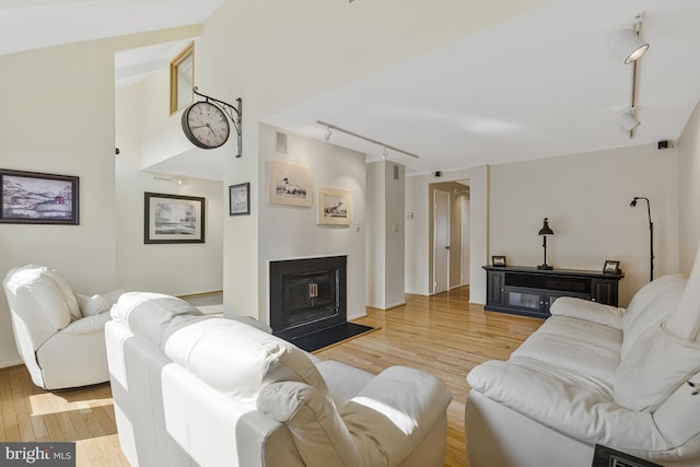 11174 Glade Dr, Reston, VA 20191 - living area with rail lighting, wood finished floors, and a fireplace