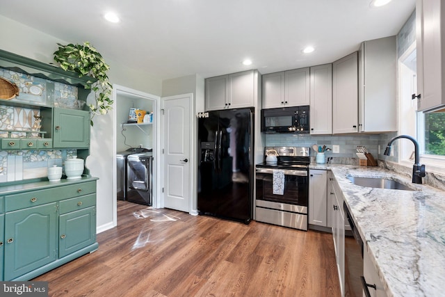 1820 Gooney Manor Loop, Bentonville, VA 22610 - kitchen featuring black appliances, a sink, independent washer and dryer, backsplash, and recessed lighting