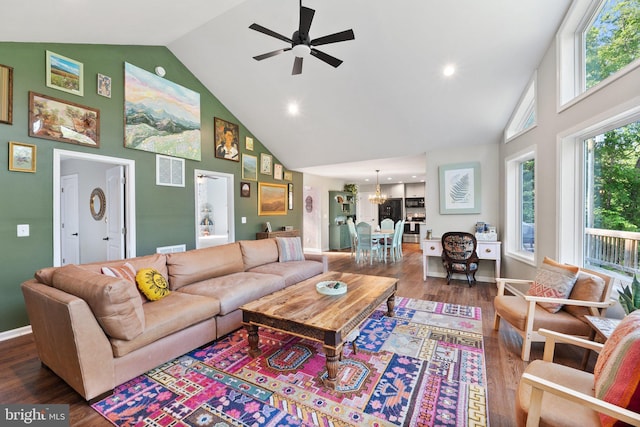 1820 Gooney Manor Loop, Bentonville, VA 22610 - living room featuring high vaulted ceiling, ceiling fan, wood finished floors, a chandelier, and baseboards