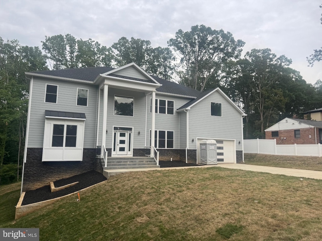 7215 Oriole Ave, Springfield, VA 22150 - view of front facade featuring stone siding, a garage, and concrete driveway