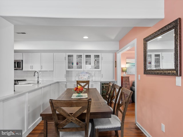 132 Seabright Way Unit D5, Rehoboth Beach, DE 19971 - dining room with wine cooler, dark wood-style flooring, recessed lighting, and baseboards