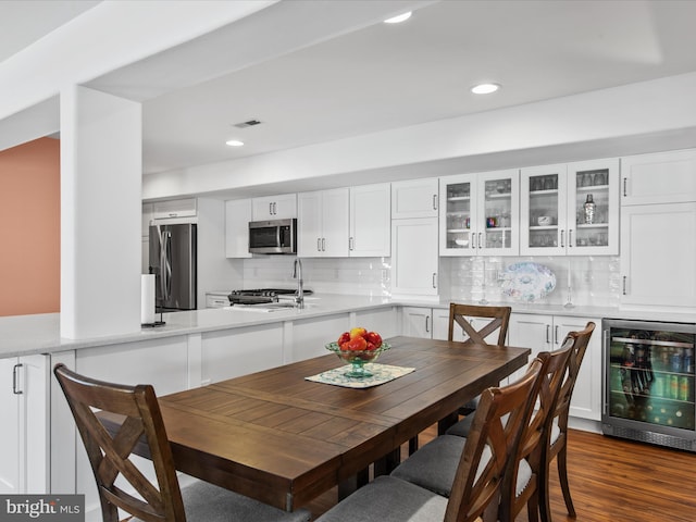 132 Seabright Way Unit D5, Rehoboth Beach, DE 19971 - dining space featuring wine cooler, recessed lighting, and dark wood finished floors