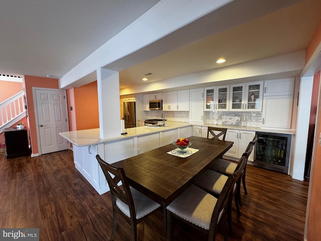 132 Seabright Way Unit D5, Rehoboth Beach, DE 19971 - dining area with wine cooler, dark wood finished floors, a dry bar, recessed lighting, and stairway