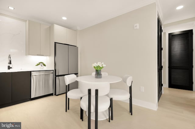 2305 Nicholson St SE Unit 305, Washington, DC 20020 - dining room with light wood finished floors, recessed lighting, crown molding, and baseboards