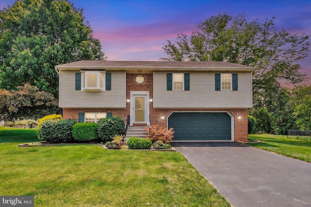425 Appaloosa Way, Red Lion, PA 17356 - bi-level home with an attached garage, driveway, a front yard, and brick siding