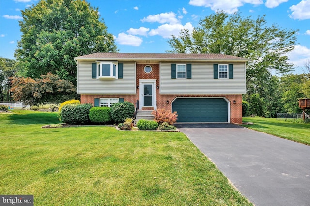 425 Appaloosa Way, Red Lion, PA 17356 - raised ranch featuring an attached garage, driveway, brick siding, and a front yard