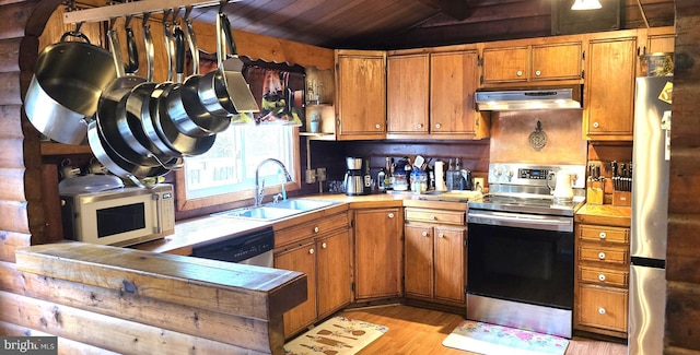 453 Mountain Heights Rd, Front Royal, VA 22630 - kitchen featuring appliances with stainless steel finishes, exhaust hood, a sink, vaulted ceiling, and light wood-type flooring