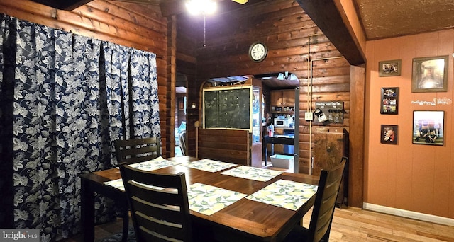 453 Mountain Heights Rd, Front Royal, VA 22630 - dining area with log walls, wood finished floors, baseboards, and a ceiling fan