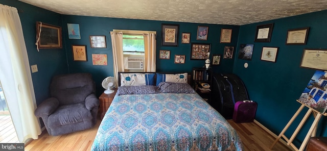 453 Mountain Heights Rd, Front Royal, VA 22630 - bedroom with wood finished floors, a textured ceiling, baseboards, and cooling unit
