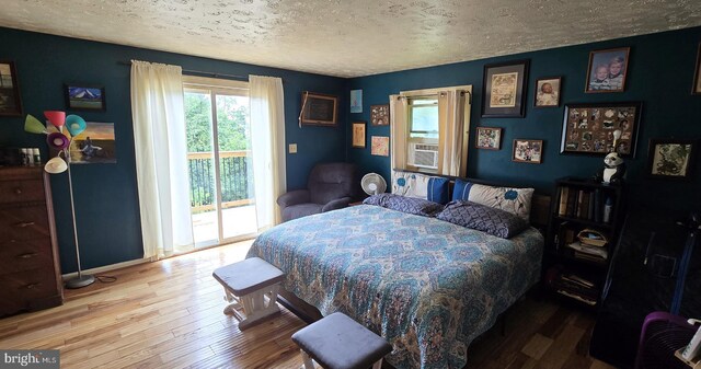 453 Mountain Heights Rd, Front Royal, VA 22630 - bedroom with a textured ceiling, access to outside, hardwood / wood-style flooring, and baseboards