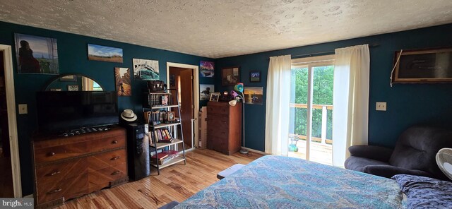 453 Mountain Heights Rd, Front Royal, VA 22630 - bedroom with wood finished floors, access to outside, a textured ceiling, and baseboards