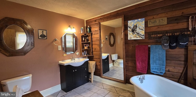 453 Mountain Heights Rd, Front Royal, VA 22630 - bathroom featuring toilet, a freestanding bath, vanity, baseboards, and tile patterned floors