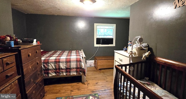 453 Mountain Heights Rd, Front Royal, VA 22630 - bedroom featuring hardwood / wood-style flooring, a textured ceiling, and cooling unit