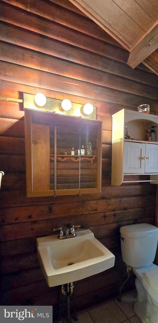 453 Mountain Heights Rd, Front Royal, VA 22630 - bathroom with log walls, toilet, a sink, wooden ceiling, and tile patterned flooring