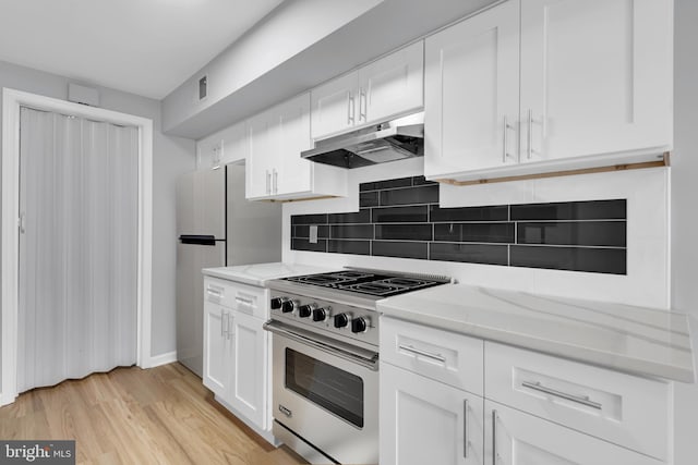 31 Ewing Dr Unit C, Reisterstown, MD 21136 - kitchen featuring high end stainless steel range oven, under cabinet range hood, decorative backsplash, and white cabinetry