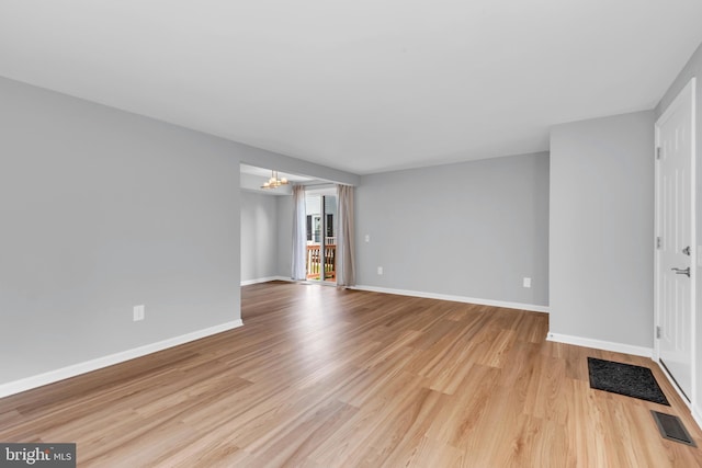 31 Ewing Dr Unit C, Reisterstown, MD 21136 - unfurnished living room featuring a chandelier and wood finished floors