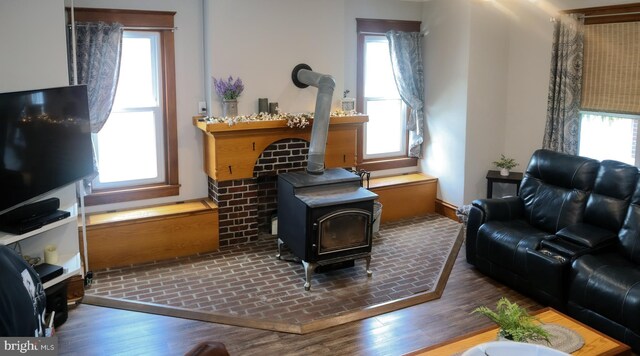 731 W Main St, Leesport, PA 19533 - living area featuring plenty of natural light, a wood stove, and wood finished floors