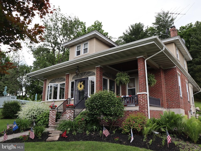 731 W Main St, Leesport, PA 19533 - view of front of house featuring brick siding, a porch, and a chimney