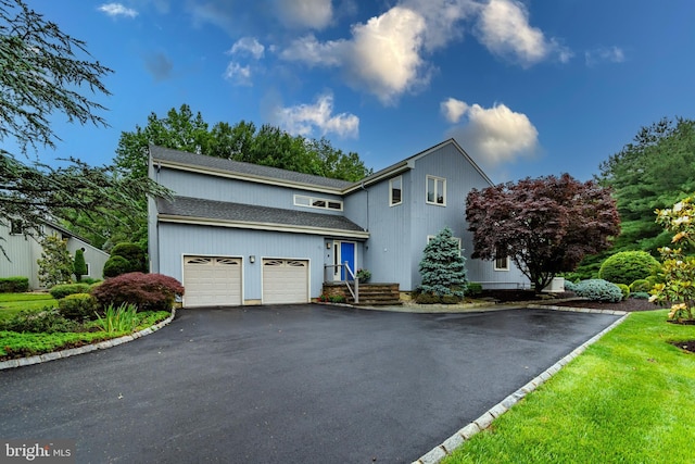 27 Arnold Dr, Princeton Junction, NJ 08550 - view of front facade with asphalt driveway, an attached garage, and a shingled roof