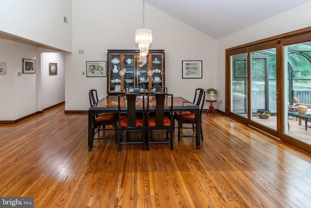 27 Arnold Dr, Princeton Junction, NJ 08550 - dining area featuring a chandelier, wood finished floors, and high vaulted ceiling