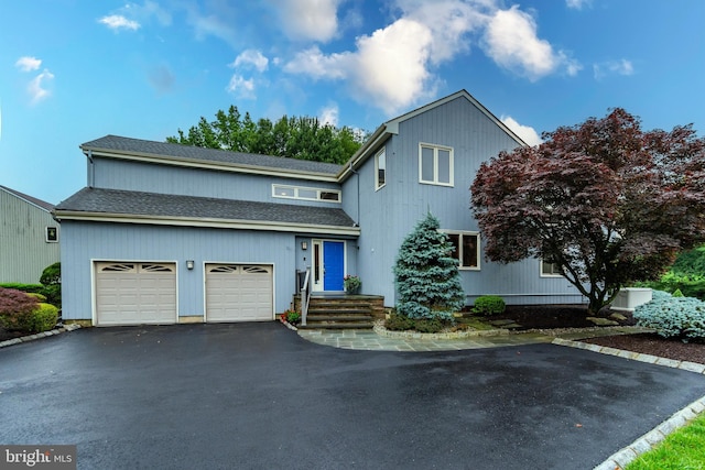 27 Arnold Dr, Princeton Junction, NJ 08550 - view of front of home with a garage, asphalt driveway, and roof with shingles