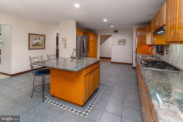 27 Arnold Dr, Princeton Junction, NJ 08550 - kitchen with appliances with stainless steel finishes, tasteful backsplash, under cabinet range hood, recessed lighting, and tile patterned flooring