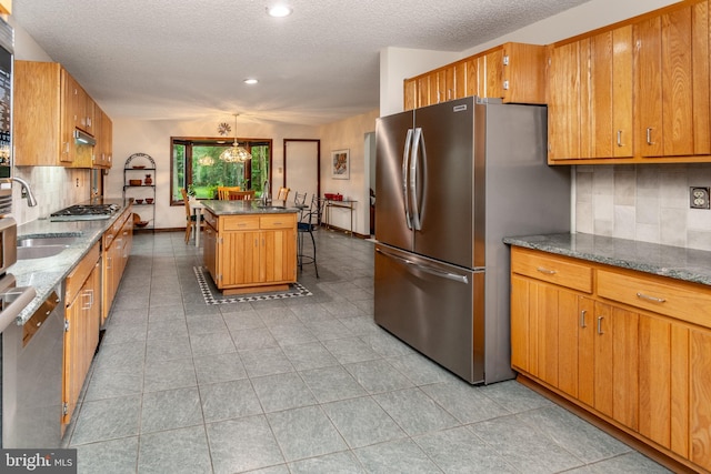 27 Arnold Dr, Princeton Junction, NJ 08550 - kitchen with stainless steel appliances, decorative backsplash, a textured ceiling, recessed lighting, and a kitchen island