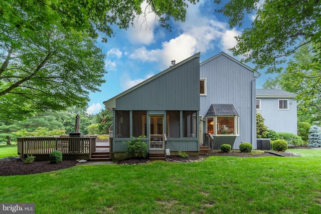 27 Arnold Dr, Princeton Junction, NJ 08550 - rear view of house featuring a sunroom, a lawn, and a deck