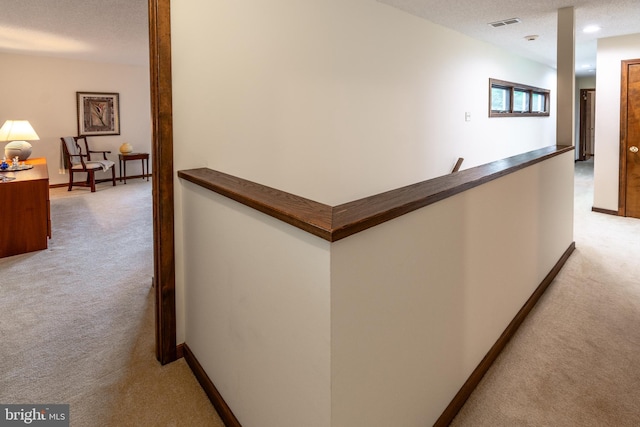 27 Arnold Dr, Princeton Junction, NJ 08550 - hallway with light carpet, an upstairs landing, and a textured ceiling