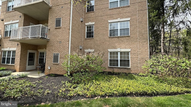 12340 Rosslare Ridge Rd Unit 204, Lutherville Timonium, MD 21093 - view of property exterior with a balcony and brick siding