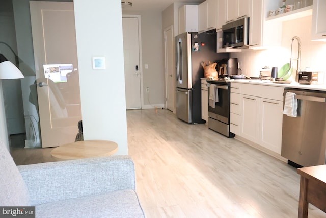 12340 Rosslare Ridge Rd Unit 204, Lutherville Timonium, MD 21093 - kitchen with stainless steel appliances, light wood-style flooring, white cabinets, light countertops, and open shelves
