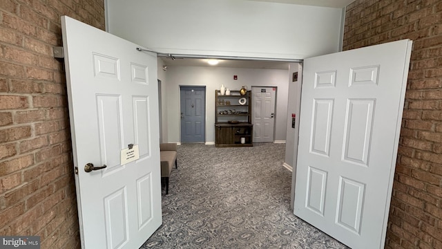 12340 Rosslare Ridge Rd Unit 204, Lutherville Timonium, MD 21093 - corridor featuring brick wall, carpet floors, and baseboards