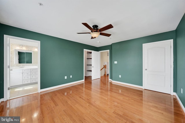 1501 Stack St, Baltimore, MD 21230 - unfurnished bedroom with wood finished floors, ensuite bath, and a ceiling fan