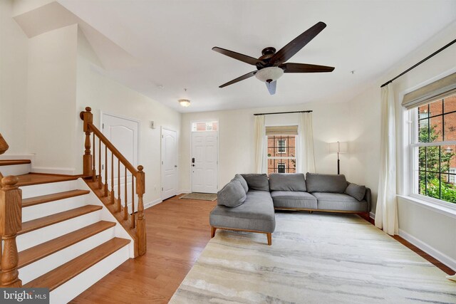 1501 Stack St, Baltimore, MD 21230 - living area with light wood-style floors, ceiling fan, and stairway