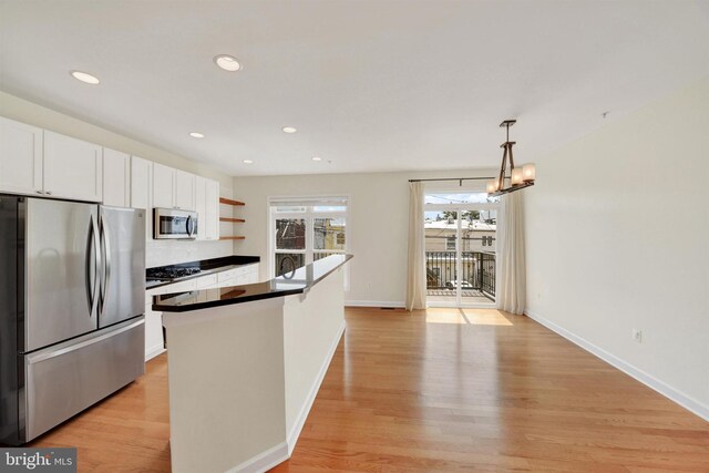 1501 Stack St, Baltimore, MD 21230 - kitchen featuring stainless steel appliances, white cabinetry, open shelves, dark countertops, and light wood finished floors
