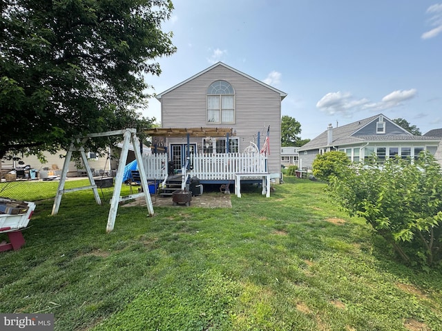 947 Martin Rd, Baltimore, MD 21221 - rear view of house featuring a wooden deck and a playground