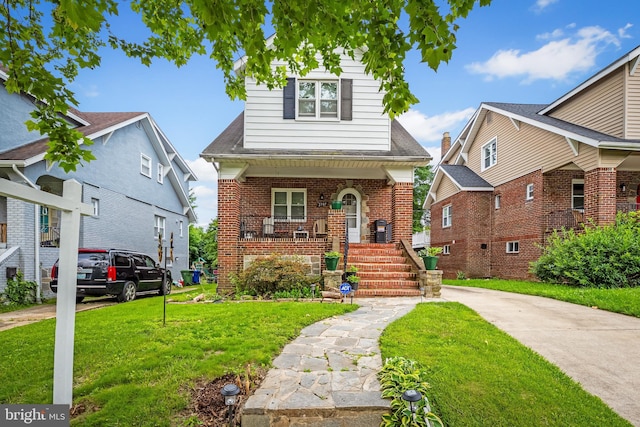 2707 Kildaire Dr, Baltimore, MD 21234 - view of front facade with a front yard, covered porch, and brick siding