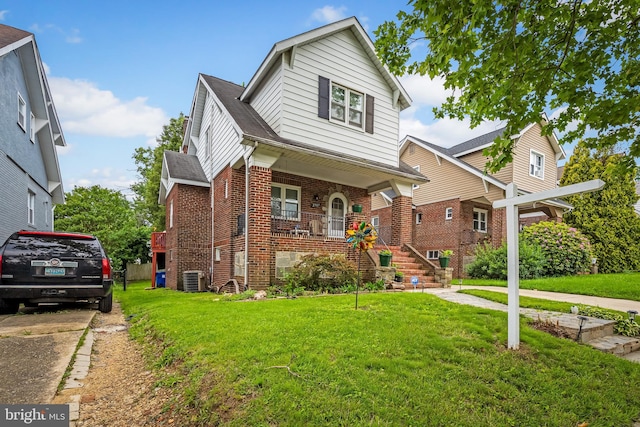 2707 Kildaire Dr, Baltimore, MD 21234 - view of front of house with brick siding, stairway, a front yard, and covered porch