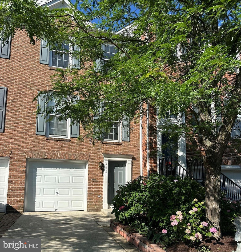 45741 Smoketree Ter, Sterling, VA 20166 - view of front of property with brick siding, concrete driveway, and an attached garage