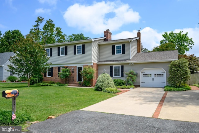 12 Hatsawap Rd, Cambridge, MD 21613 - colonial inspired home with a garage, a chimney, concrete driveway, a front lawn, and brick siding