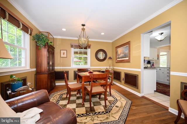 12 Hatsawap Rd, Cambridge, MD 21613 - dining space featuring light wood-style flooring, plenty of natural light, a chandelier, recessed lighting, and crown molding
