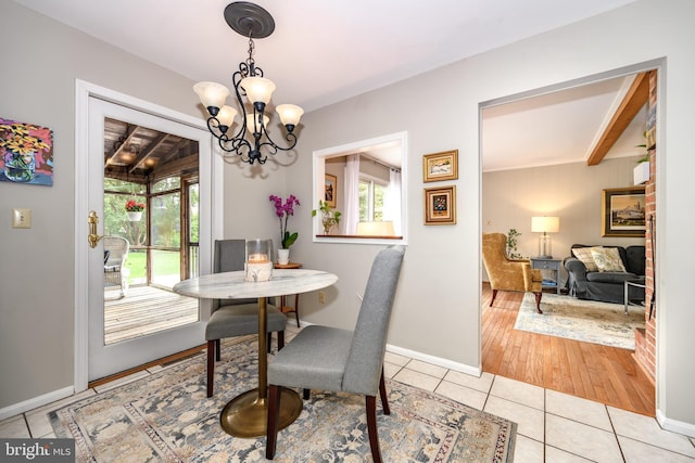 12 Hatsawap Rd, Cambridge, MD 21613 - dining room with a chandelier, light tile patterned floors, baseboards, and beam ceiling