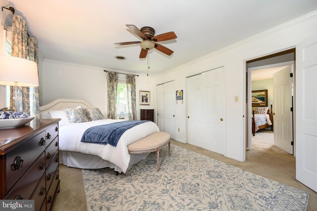 12 Hatsawap Rd, Cambridge, MD 21613 - bedroom featuring multiple closets, light colored carpet, ornamental molding, and a ceiling fan