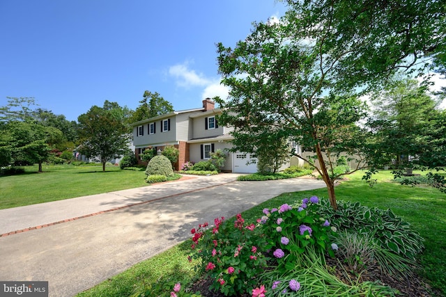 12 Hatsawap Rd, Cambridge, MD 21613 - view of front facade with driveway, a front yard, a chimney, an attached garage, and brick siding