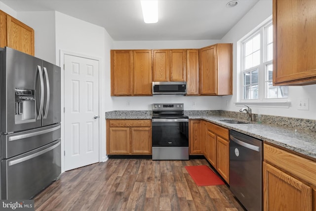 605 Red Timber Ln, Smyrna, DE 19977 - kitchen with appliances with stainless steel finishes, dark wood-style floors, light stone countertops, and brown cabinets