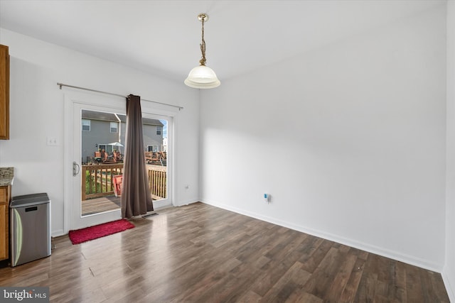 605 Red Timber Ln, Smyrna, DE 19977 - unfurnished dining area with dark wood-style flooring and baseboards